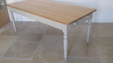 A 19th century pine kitchen table with one drawer and a dummy drawer painted base and re-polished