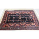 A hand knotted woollen Luri rug - 2.13m x 1.48m