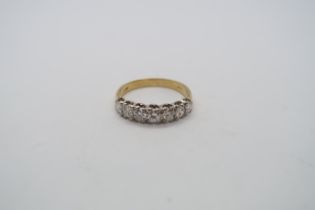 A hallmarked 18ct yellow gold diamond 7 stone bridge ring with round cut diamonds, size O/P,