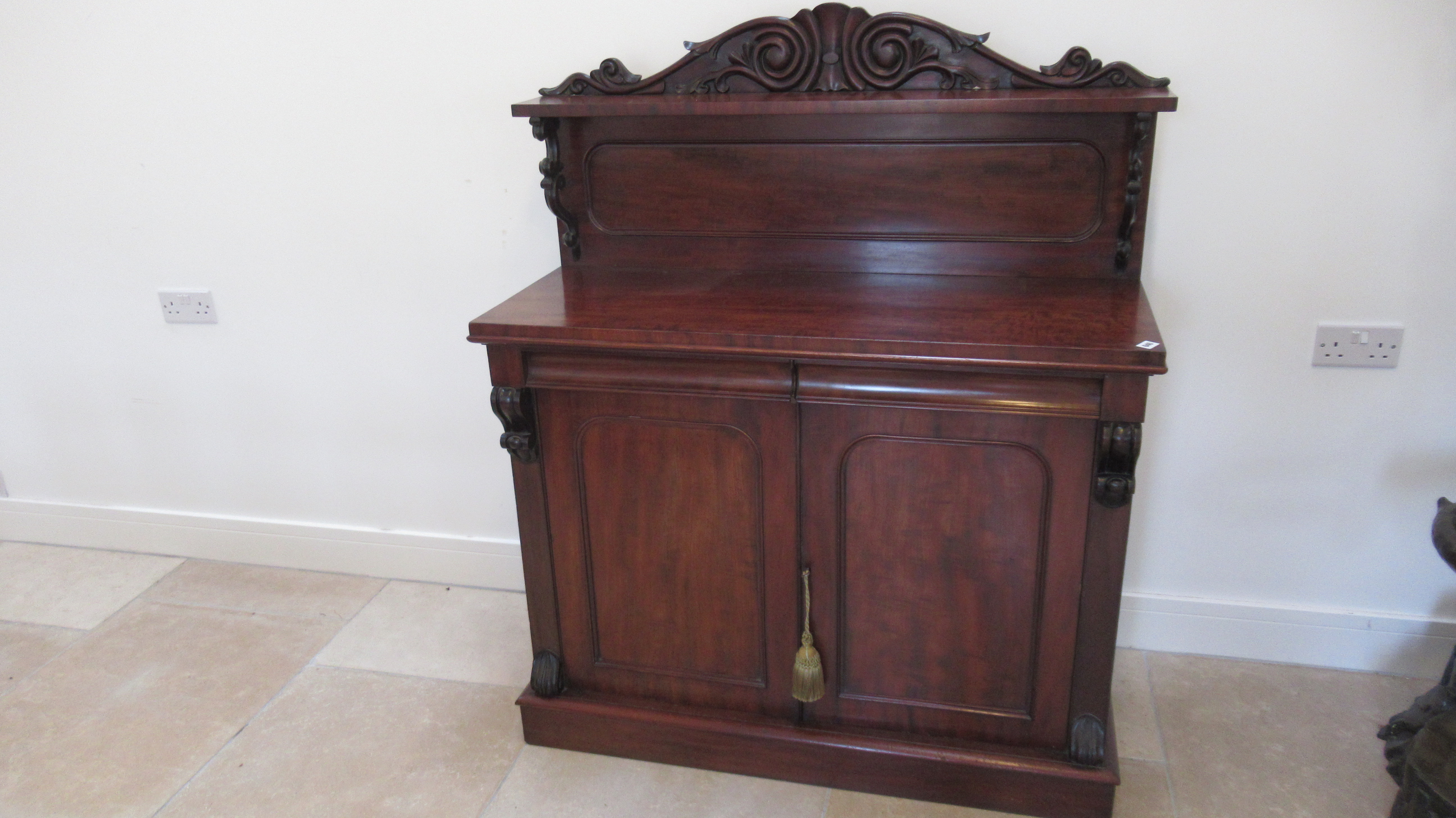 A good quality flame mahogany chiffonier with two drawers over two cupboard doors with a good patina