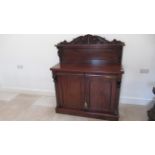 A good quality flame mahogany chiffonier with two drawers over two cupboard doors with a good patina