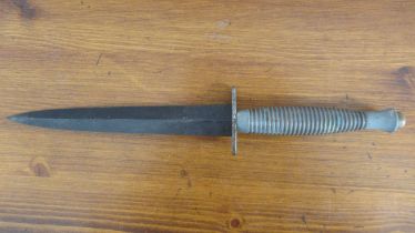 A Fairbairn Sykes type commando knife, 17.5cm blade with no markings and painted brass grip