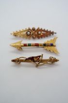 Three gold brooches; Etruscan revival with seed pearls, 5cm, a 15ct hallmarked gold and enamel 4.