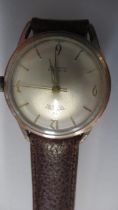 A gents Trident Incabloc with second hand on a brown leather strap - working in the saleroom -