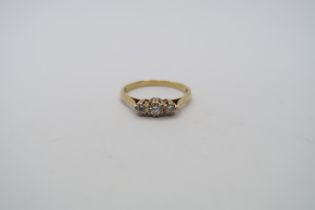 A hallmarked 18ct yellow gold three stone diamond ring, size P, approx 2.6 grams