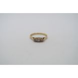 A hallmarked 18ct yellow gold three stone diamond ring, size P, approx 2.6 grams