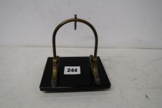 A black onyx and brass pocket watch stand, 12cm x 9cm