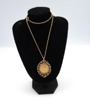 A 1895 full Sovereign, held within a 9ct gold pendant surround with a 9ct gold necklace. Total