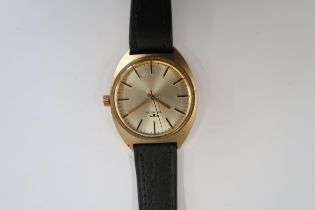 A Gents Technos automatic watch with gold face on a black leather strap, running in saleroom