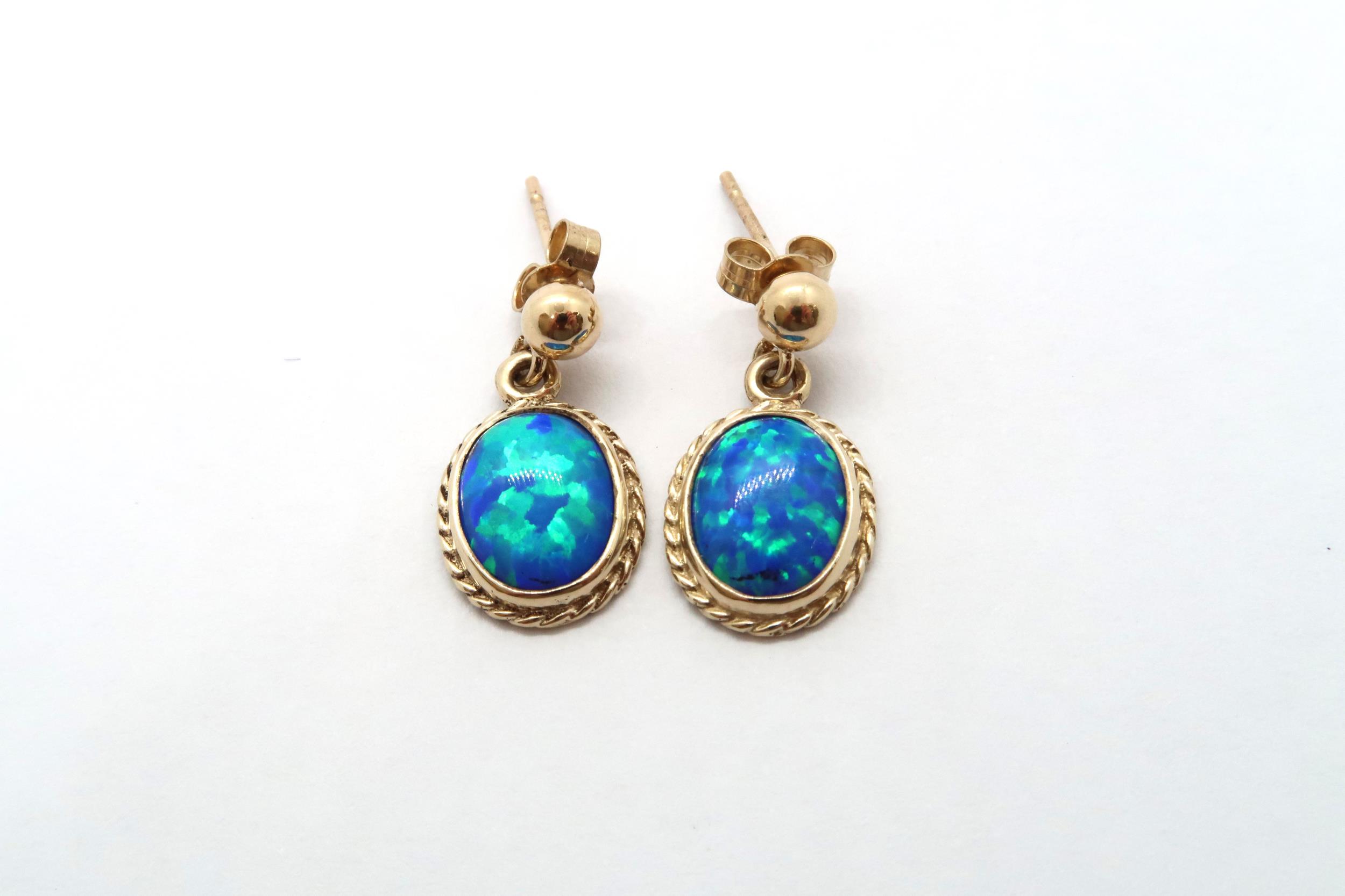 A 9ct yellow gold opal earrings, head size including ball mounts 20mm x 11mm
