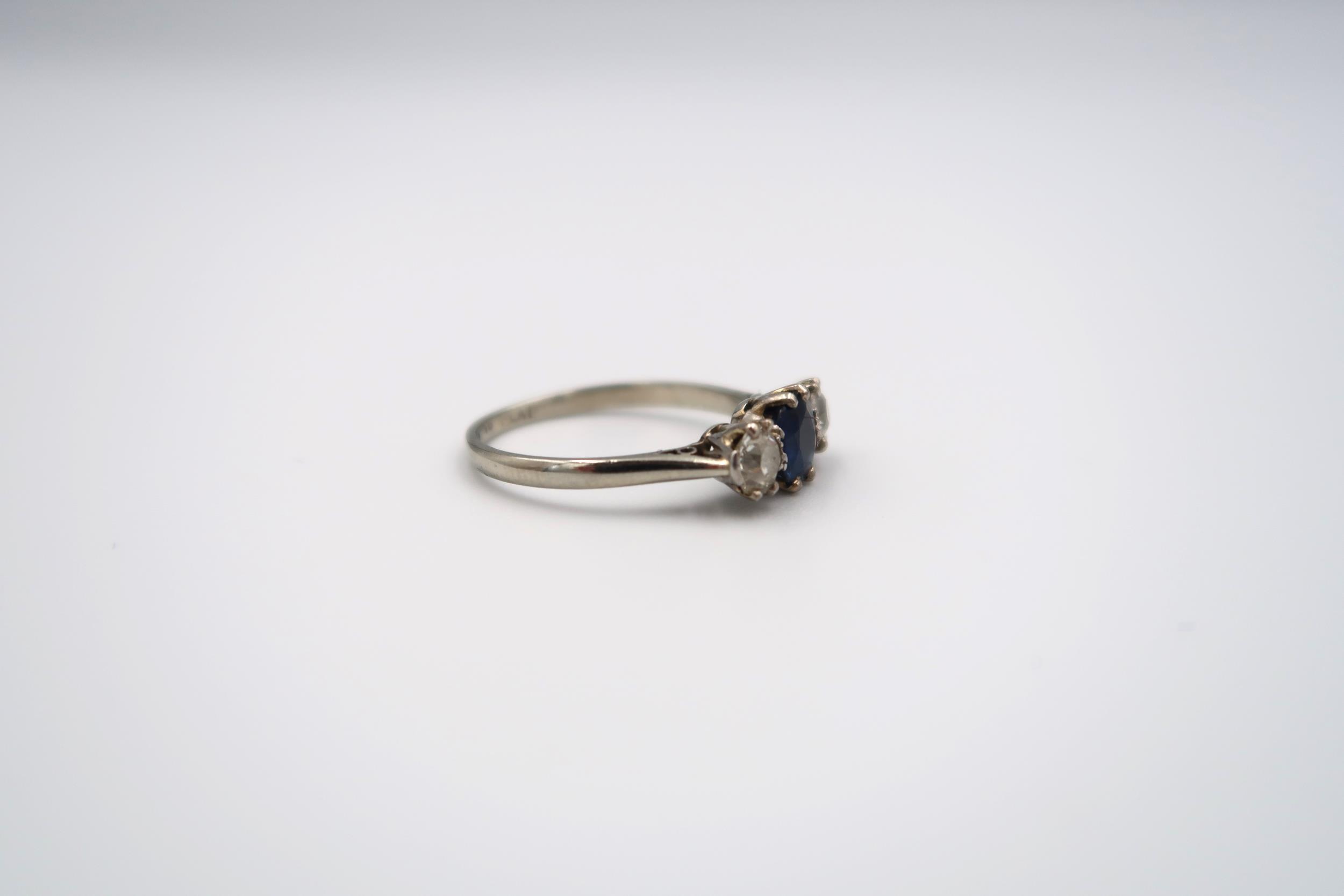 A sapphire and diamond three stone ring. The off round central sapphire to the old cut diamonds. - Image 2 of 3