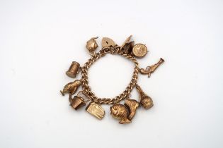 A 9ct gold charm bracelet with 12 charms - weight approx 38.7 grams