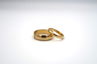 An 18ct yellow gold wedding band ring, size G, approx 2 grams together with a gold plated ring, size