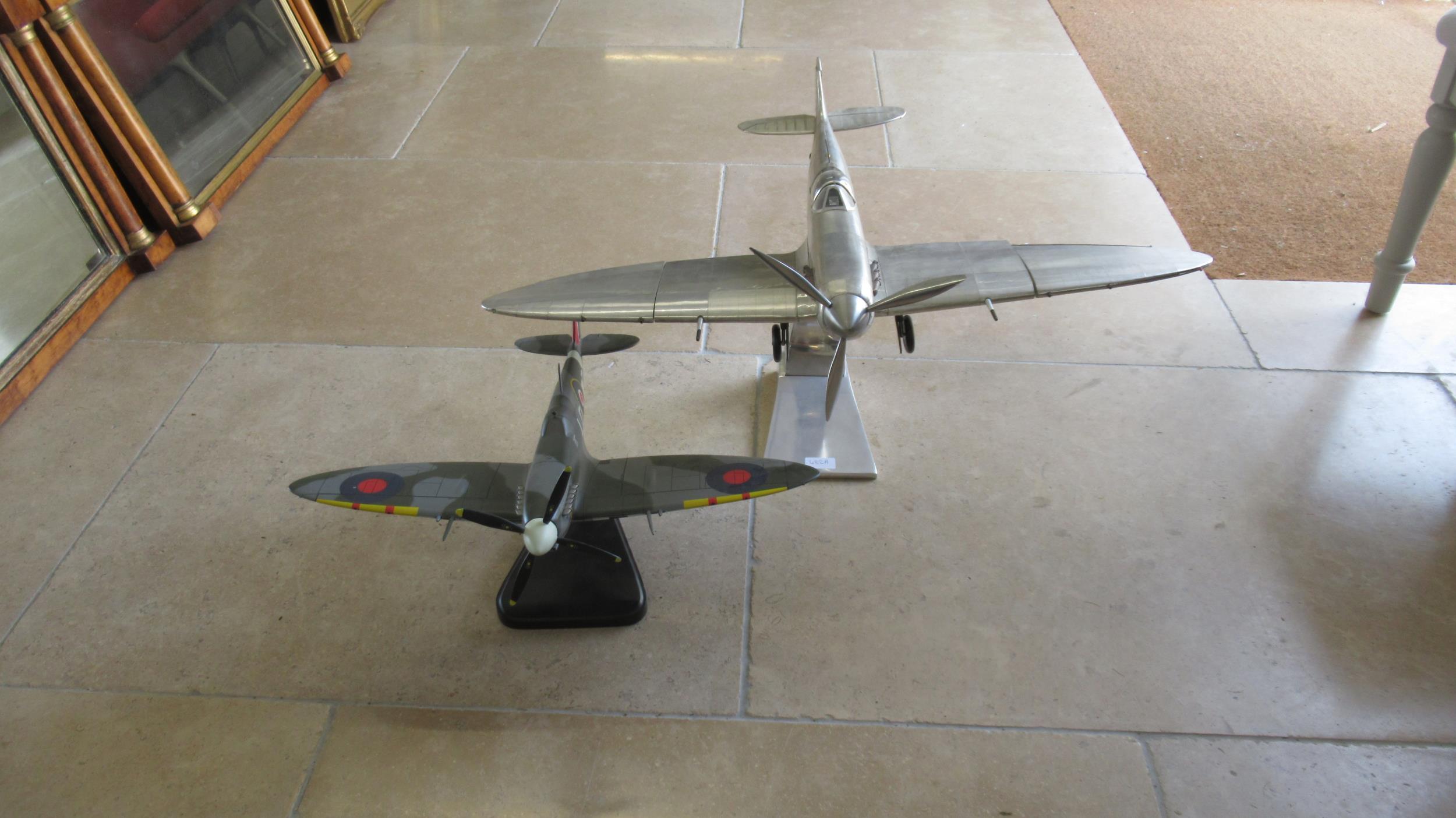 A large scale model of a Spitfire and one smaller painted example - size nose to tail 60cm and