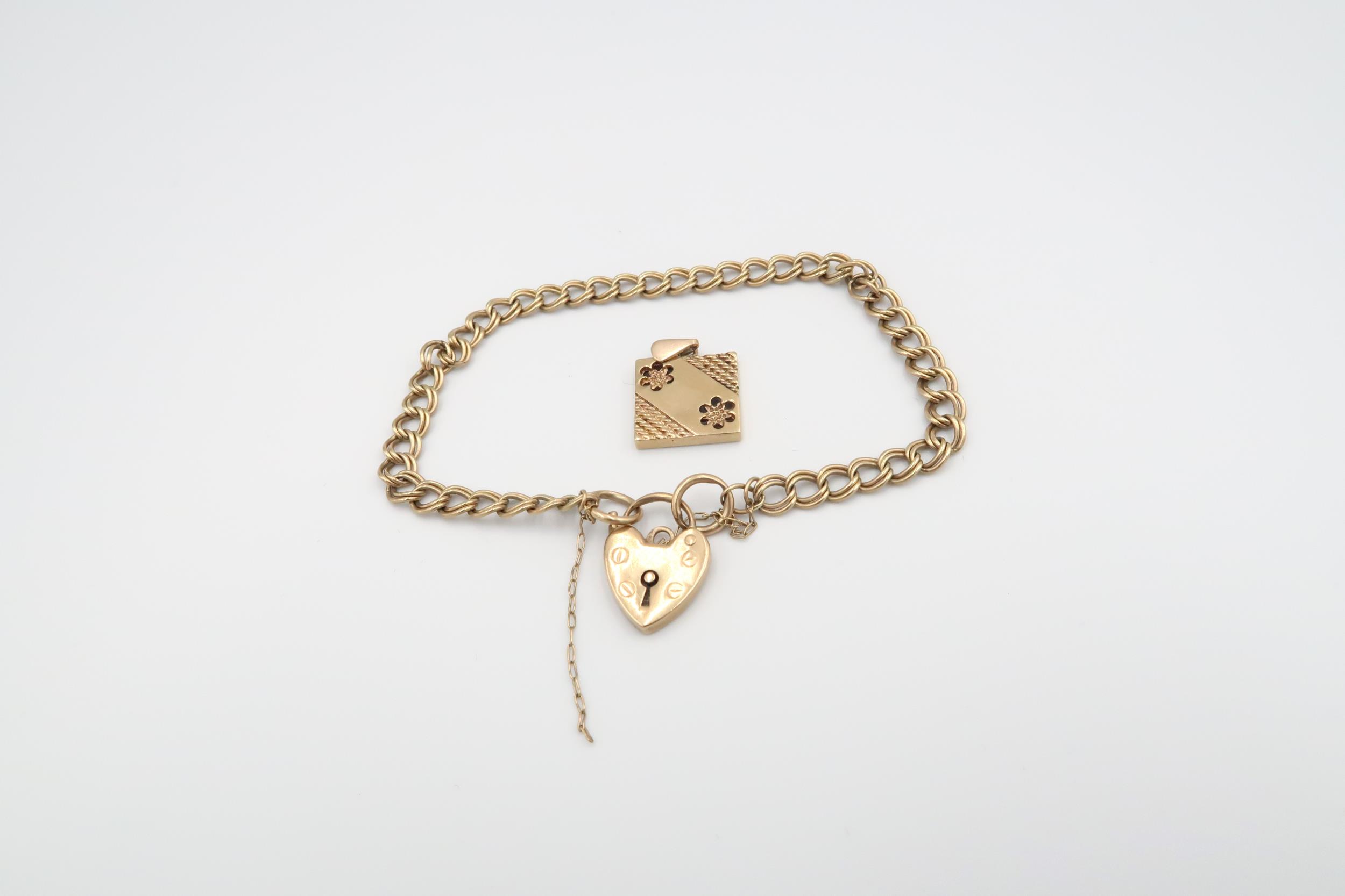 A 9ct yellow gold bracelet with heart lock and floral panel, 9.5cm diameter, approx 10 grams