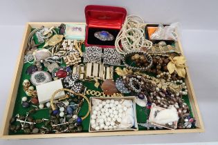A selection of costume jewellery, items include brooches, bracelets and necklaces