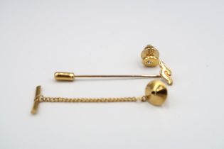 Three gold items to include a yellow metal tie pin, a shirt stud with diamond to centre and another