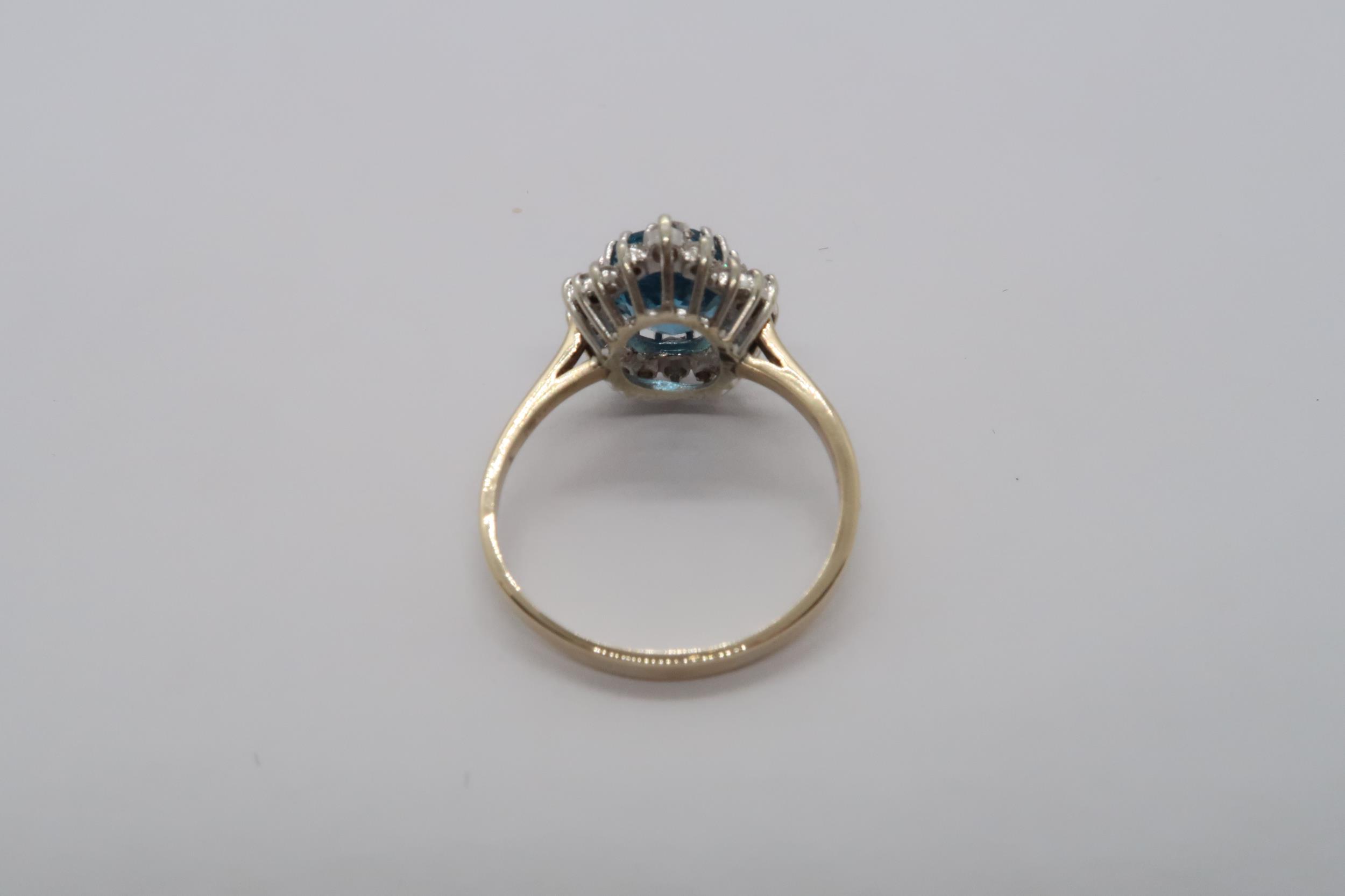 A 9ct yellow gold blue topaz and diamond ring, topaz is a good colour, diamonds bright and lively, - Image 3 of 3