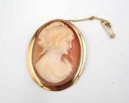 A probably 9ct yellow gold mounted cameo brooch of oval form - approx 6cm x 4cm