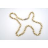 A simulated pearl necklace, approx 50cm long, with 9ct gold clasp