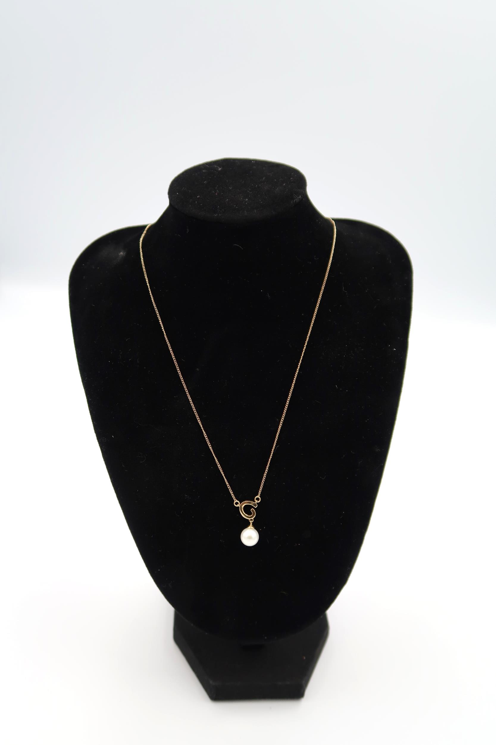 A 9ct yellow gold pearl and diamond pendant on 22 inch chain - ex jewellers stock, as new