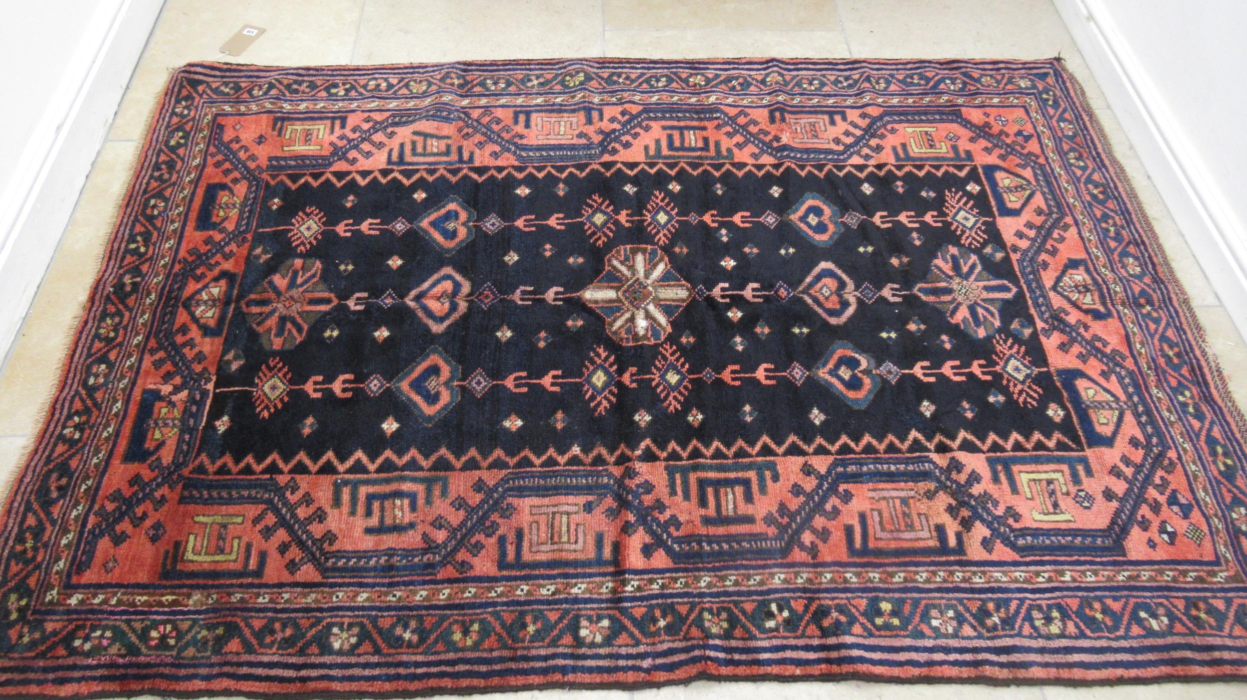 A hand knotted woollen Luri rug - 2.13m x 1.48m