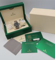 A Rolex Submariner watch, boxed with all paperwork, swing tag and original receipt dated 10/7/2020