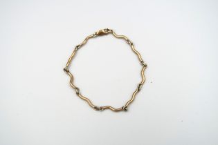 A 9ct bi-colour gold 'wave' bracelet. Weight 7.40 grams