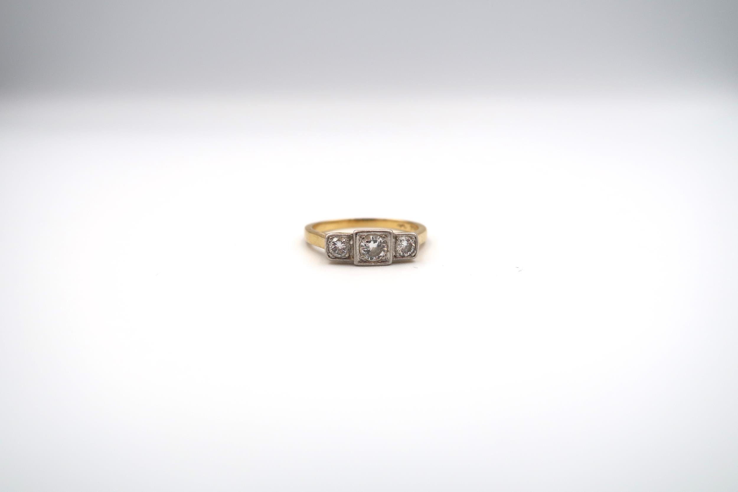 A brilliant cut diamond three stone ring. Estimated total diamond weight 0.50ct. Estimated H/I