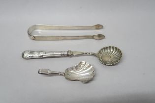 A hallmarked silver strainer and sugar nips - approx weight 2.08 troy oz - and a silver spoon - 0.23