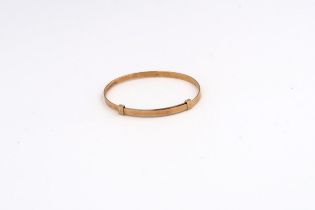 A child's adjustable bangle. Stamped 14K. Weight 4.29 grams.