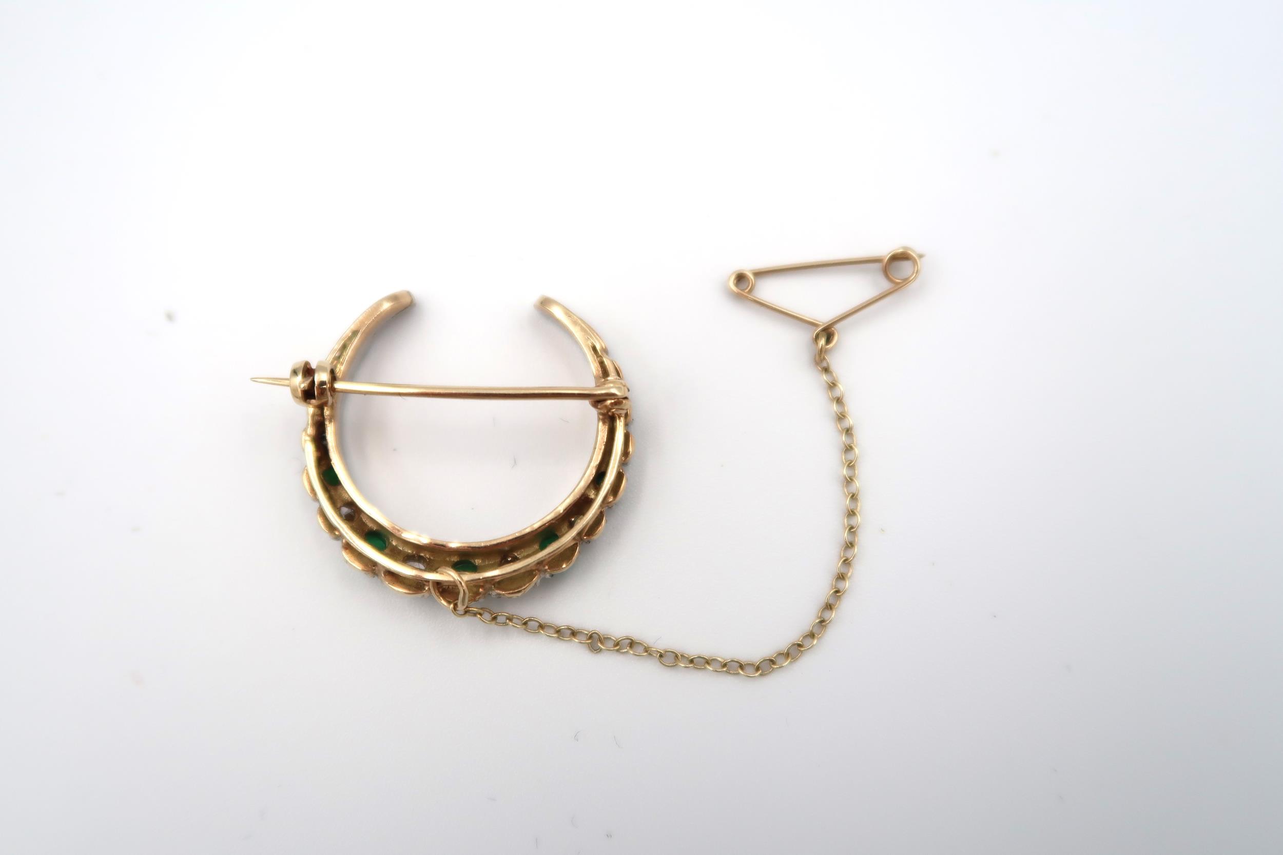 A 9ct gold graduated emerald and diamond crescent brooch. Composed of nine circular emeralds - Image 2 of 3