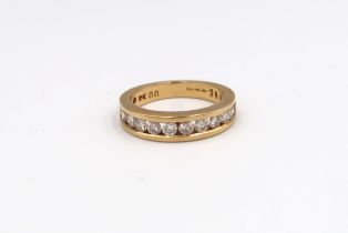 A hallmarked 18ct yellow gold diamond half eternity ring, 12 round brilliant cut diamonds with