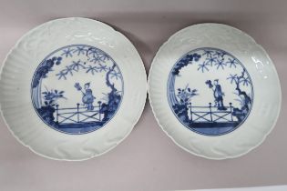 Two Oriental blue and white plates decorated with figure on bridge with foliage to background, 21.
