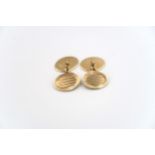 A pair of 9ct yellow gold cufflinks of oval form, engraved decoration, approx 11 grams