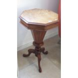 A Victorian walnut trumpet shaped needlework table with fitted interior