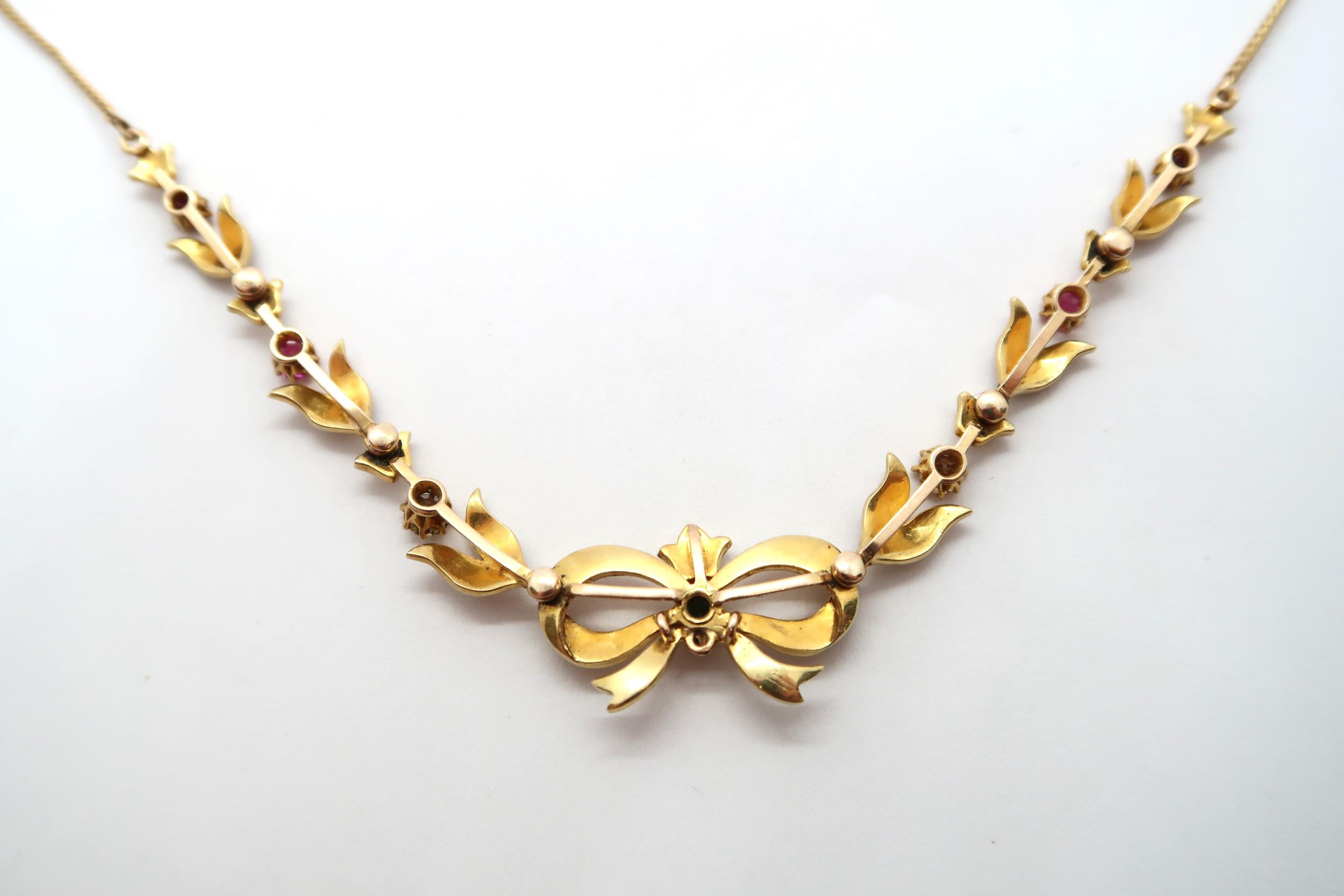 A seed pearl and gem set necklace, with central bow and foliate lines to the curb link chain. Gems - Image 6 of 6