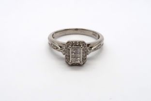 A paladium Art Deco style diamond cluster ring with diamond shoulders, head size approx 9mm x 8mm,