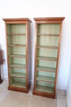 A pair of slim walnut bookcases with five adjustable shelves - 180cm x 52cm x 26cm deep- made by a