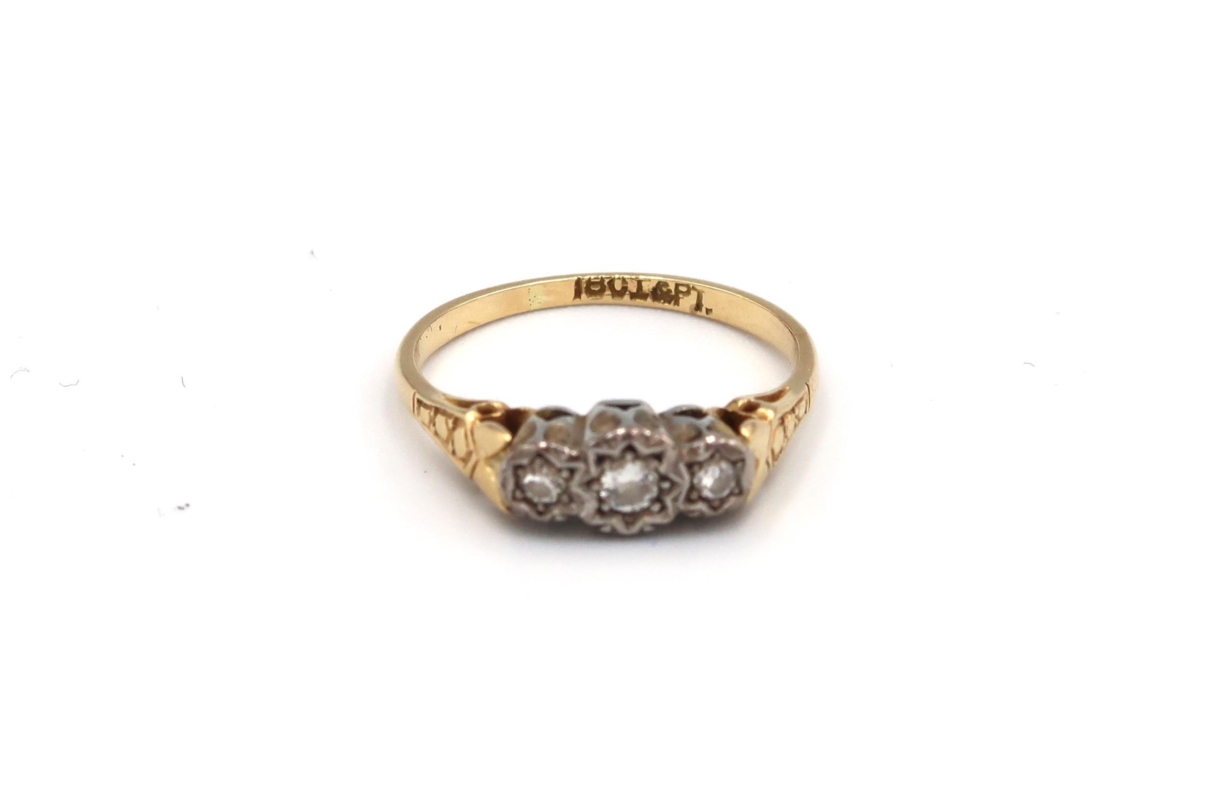 A 18ct yellow gold and platinum three stone diamond ring, size J 2.08 grams