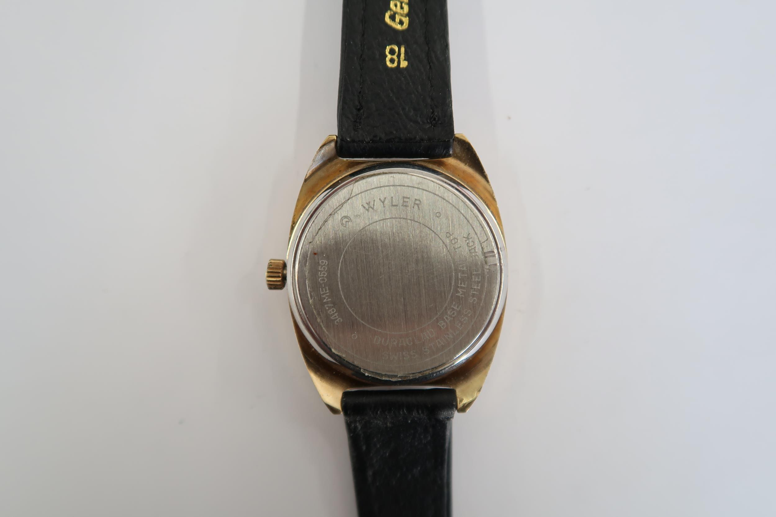 A Gents Technos automatic watch with gold face on a black leather strap, running in saleroom - Image 2 of 3