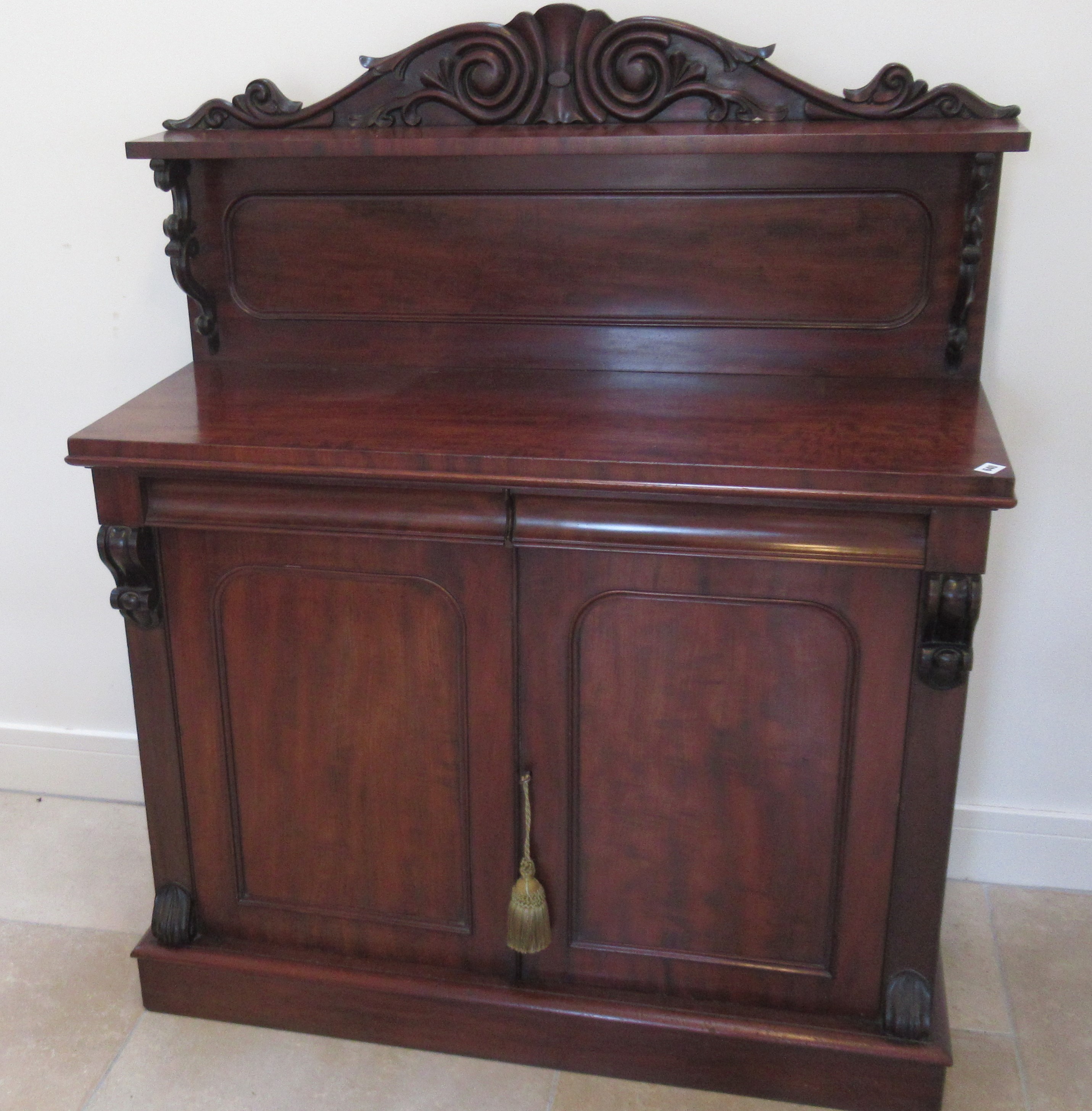 A good quality flame mahogany chiffonier with two drawers over two cupboard doors with a good patina
