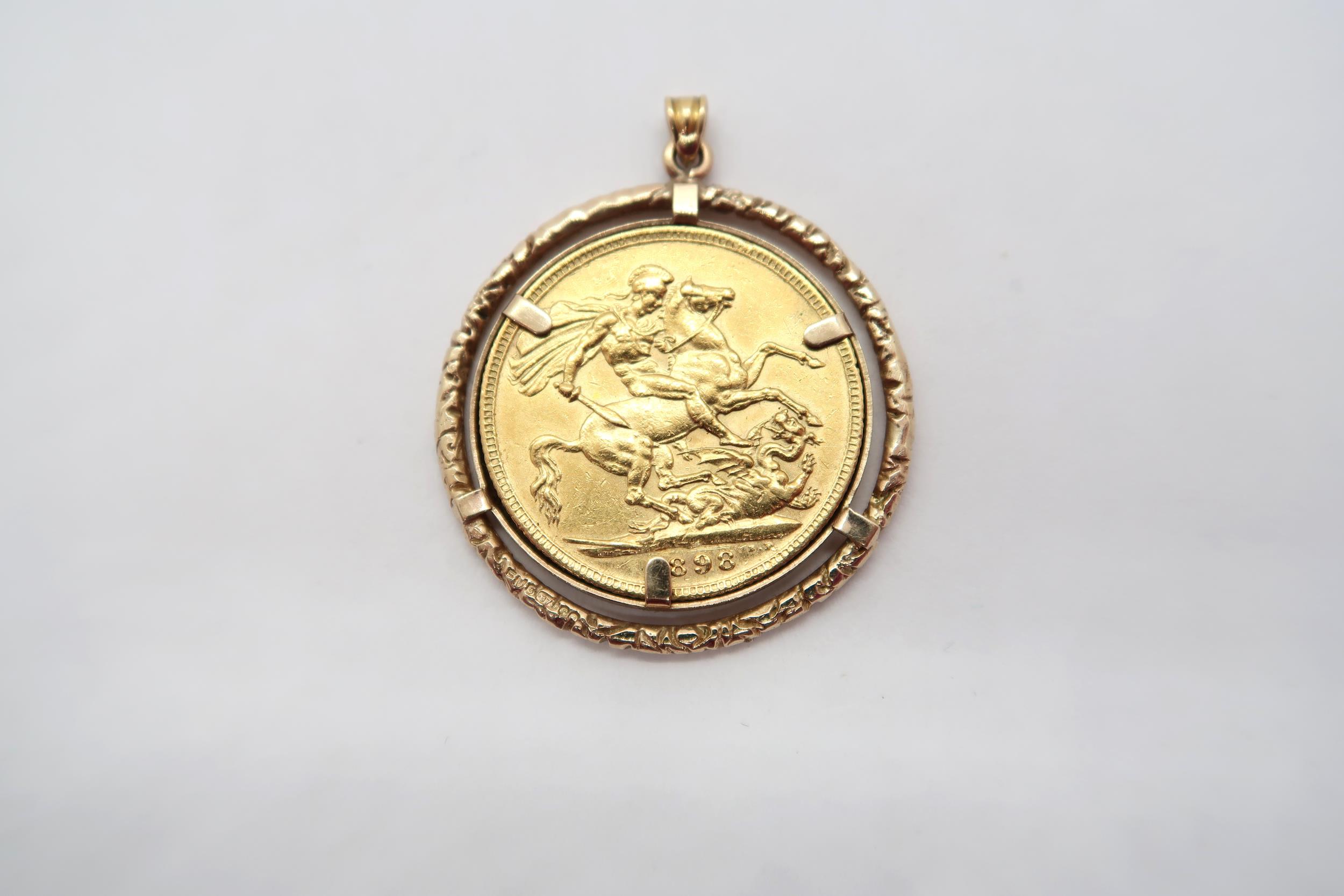 A Victorian sovereign dated 1898 in a gold mount - total weight approx 10.5 grams