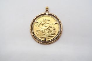A Victorian sovereign dated 1898 in a gold mount - total weight approx 10.5 grams