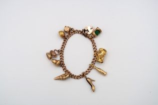 A 9ct gold charm bracelet - approx weight 27.5 grams - ten charms
