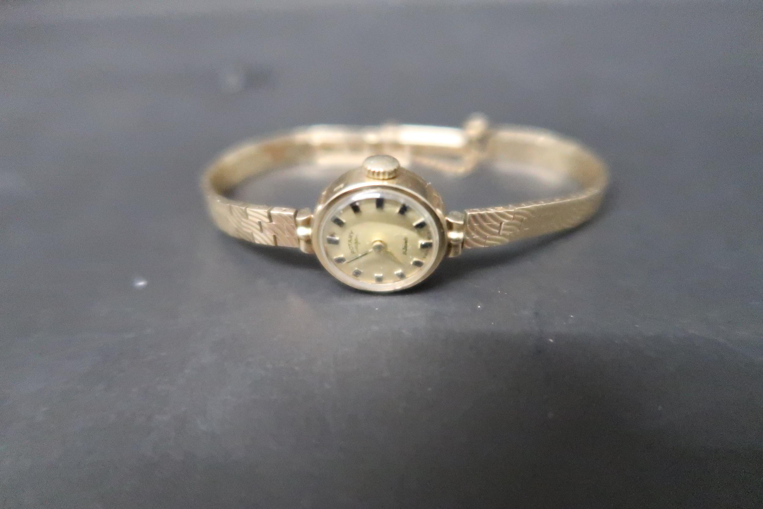 A ladies 9ct yellow gold cased Rotary watch with gold face and baton markers on 9ct gold bracelet