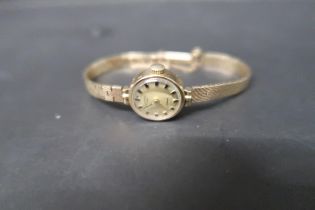 A ladies 9ct yellow gold cased Rotary watch with gold face and baton markers on 9ct gold bracelet