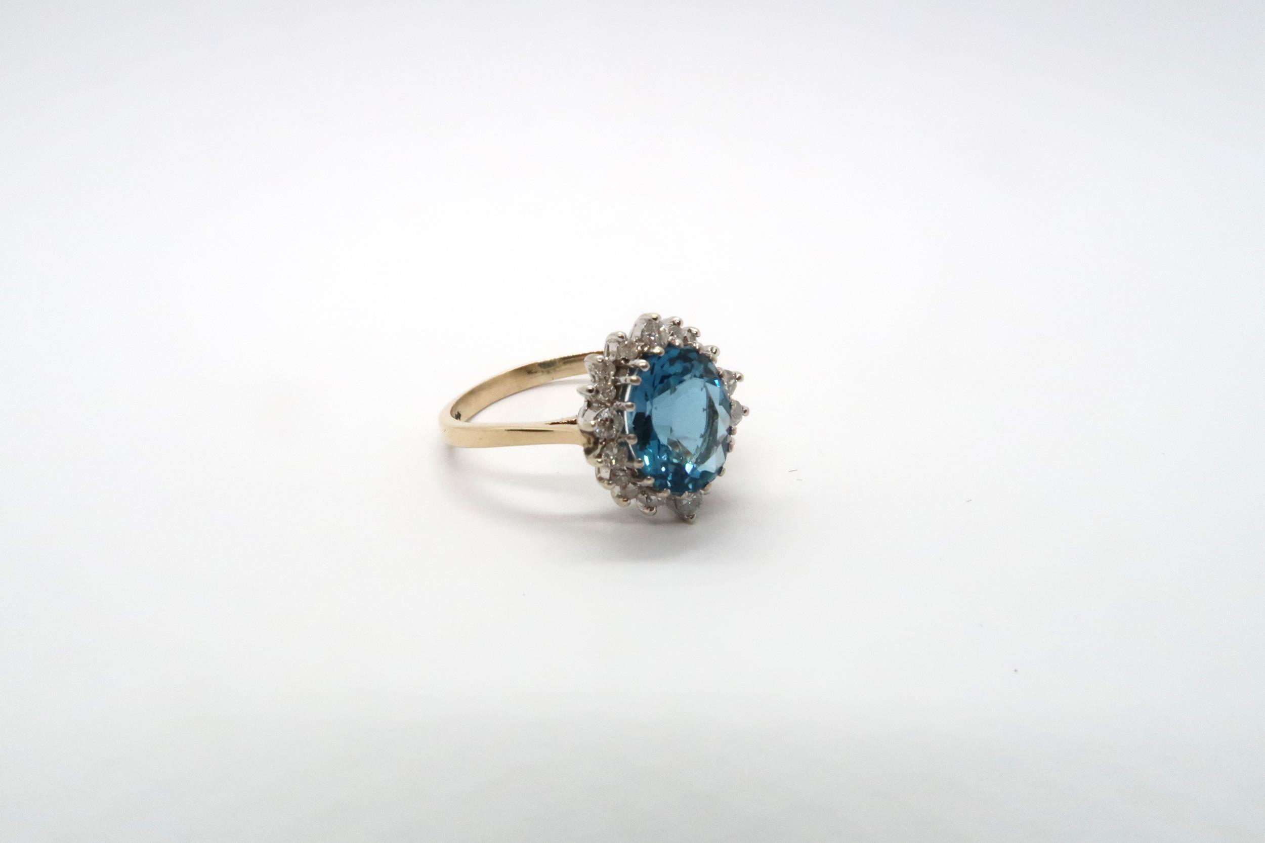 A 9ct yellow gold blue topaz and diamond ring, topaz is a good colour, diamonds bright and lively, - Image 2 of 3