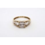 A 9ct yellow gold square cut topaz ring with baguette cut shoulders, head size approx 19mm x 8mm,