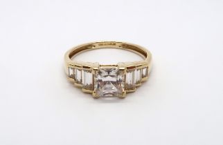 A 9ct yellow gold square cut topaz ring with baguette cut shoulders, head size approx 19mm x 8mm,